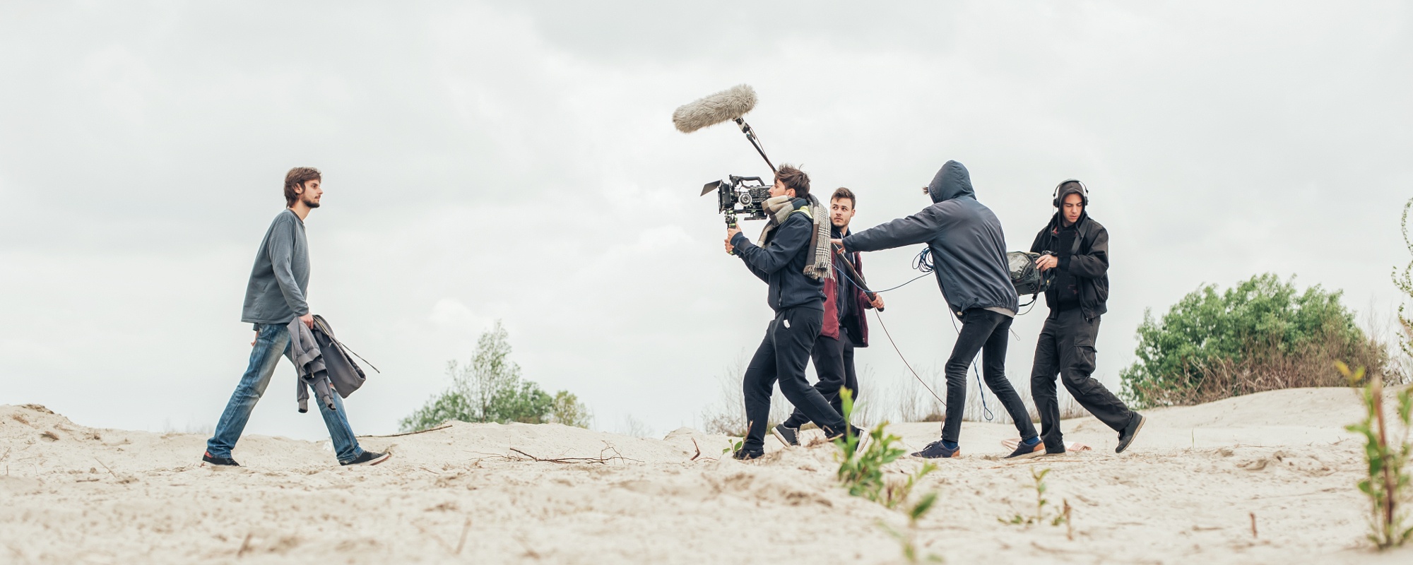 Location-sound-recordist-in-action-with-camera-crew-of-film-production-2 Location sound recordist in action with camera crew of film production
